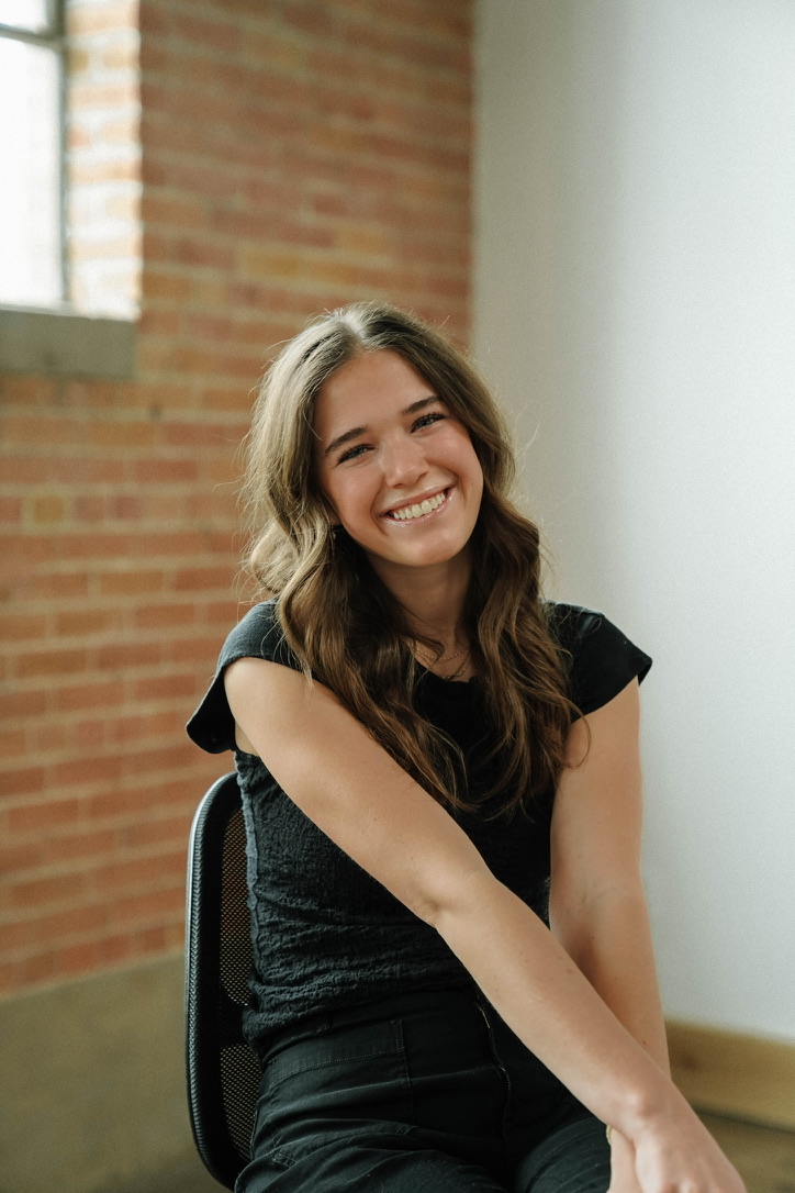Mylie Jane Derrick smiling in a studio portrait.